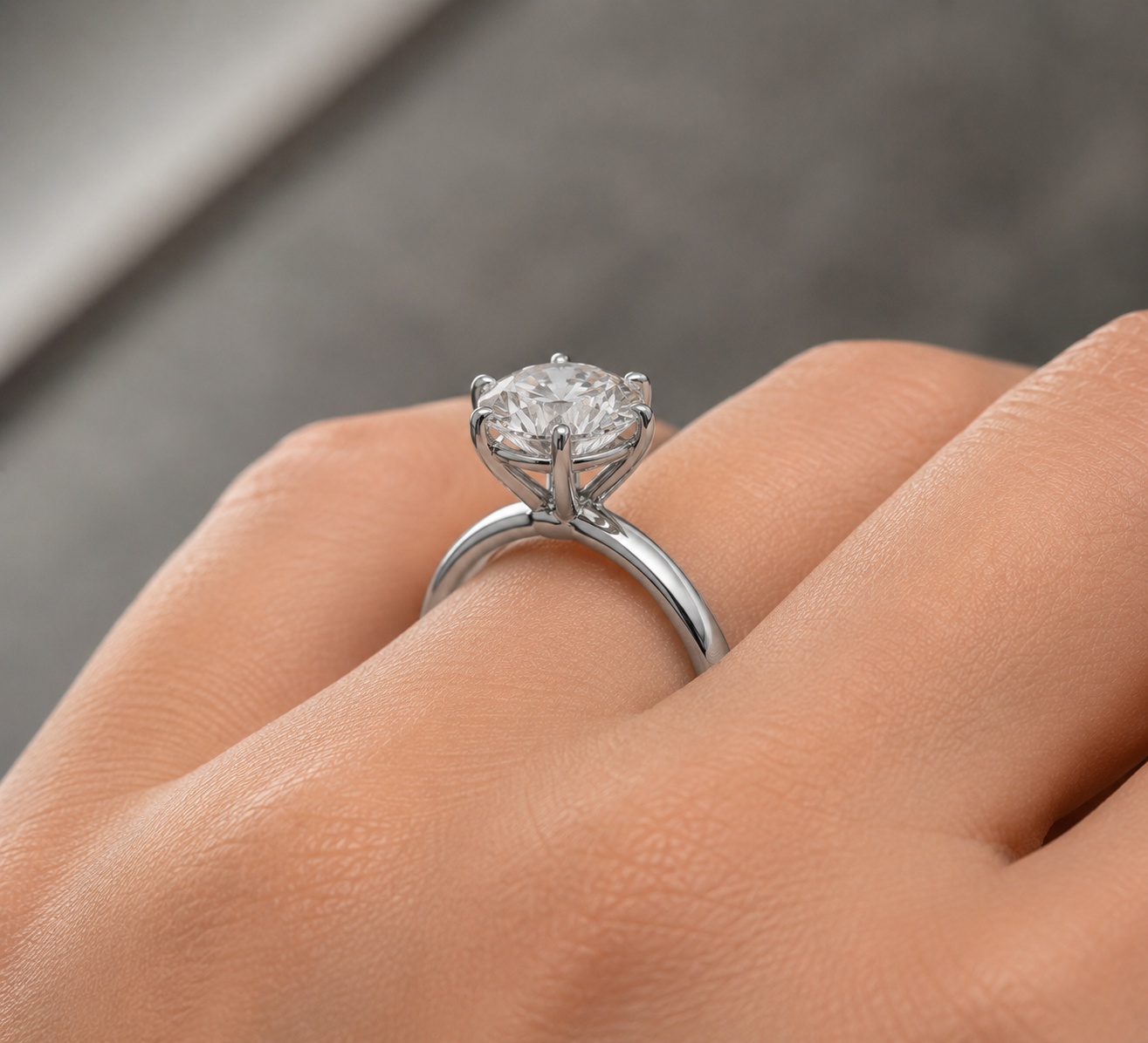 Diamond ring on a finger with a blurred background