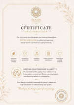A decorative Certificate of Authenticity from Danish Jewellers, featuring elegant cream and gold typography, ornamental borders, and icons highlighting genuine natural stones, craftsmanship, and a lifetime warranty.