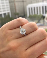 Diamond ring on a hand with a blurred outdoor background